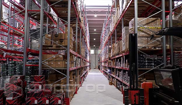 The racks store goods both on pallets and on shelves