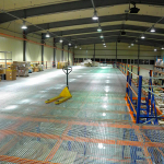 Pressed flooring in a warehouse storage system
