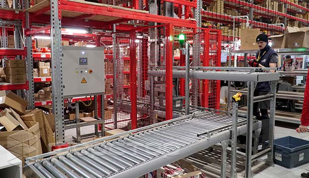 Conveyor moves order trays between all levels